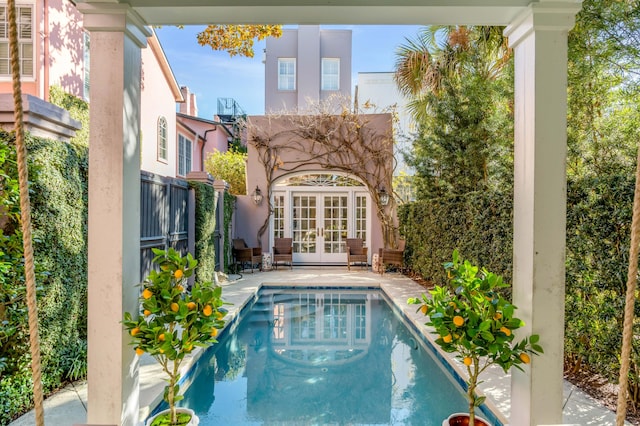 view of swimming pool featuring french doors and a patio area