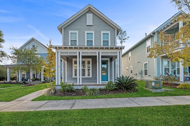 view of front of home with cooling unit and a front lawn