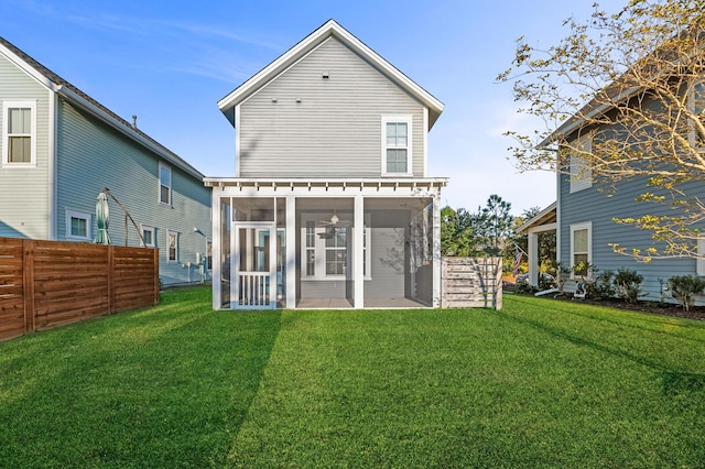 back of property featuring a sunroom and a yard