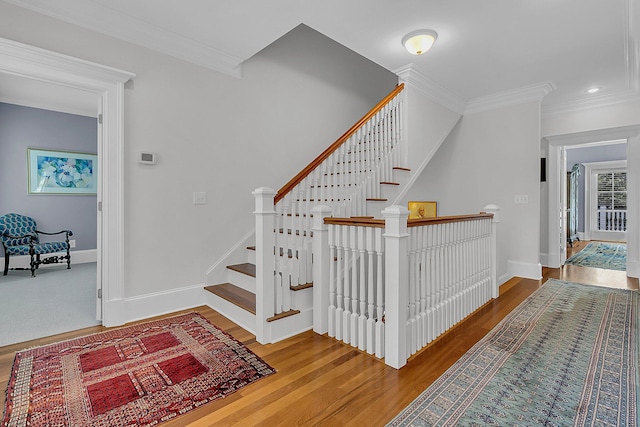 stairway featuring hardwood / wood-style floors and ornamental molding