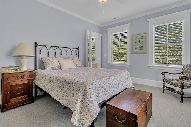 carpeted bedroom featuring crown molding and ceiling fan