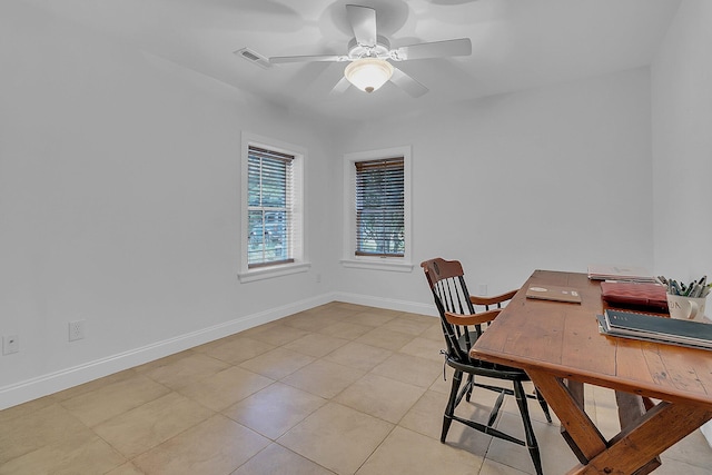 office space with ceiling fan and light tile floors