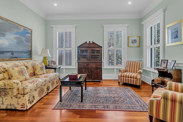 living room with wood-type flooring and ornamental molding