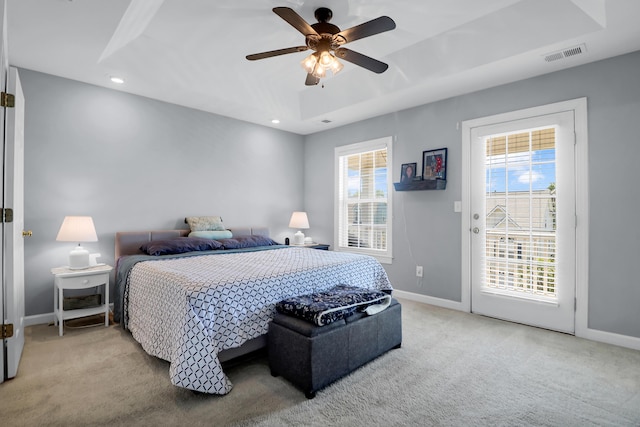 bedroom featuring visible vents, carpet floors, baseboards, access to outside, and a raised ceiling