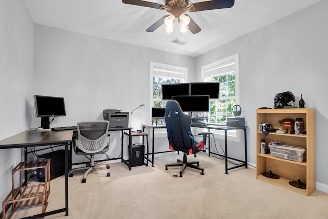 home office featuring visible vents, a ceiling fan, and carpet floors