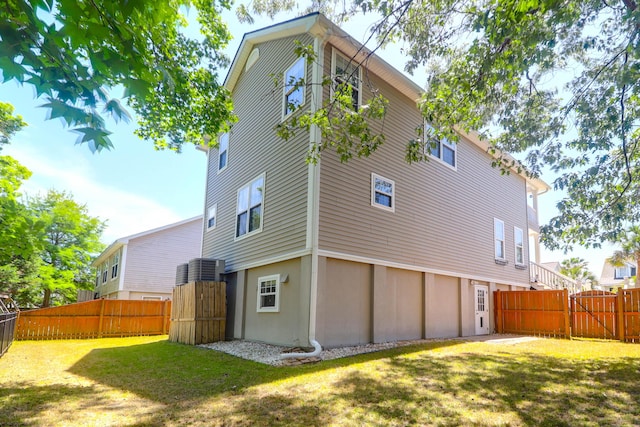 back of house featuring fence and a yard