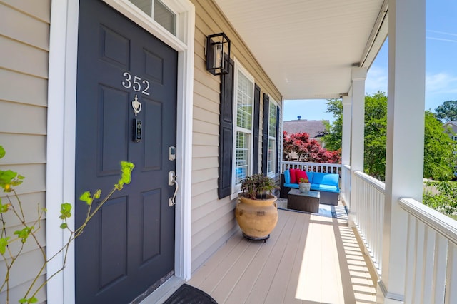 view of exterior entry featuring covered porch
