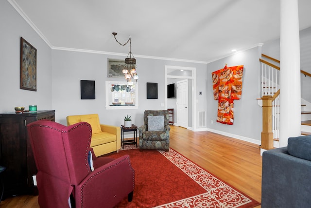 living room with ornamental molding, stairs, wood finished floors, and visible vents