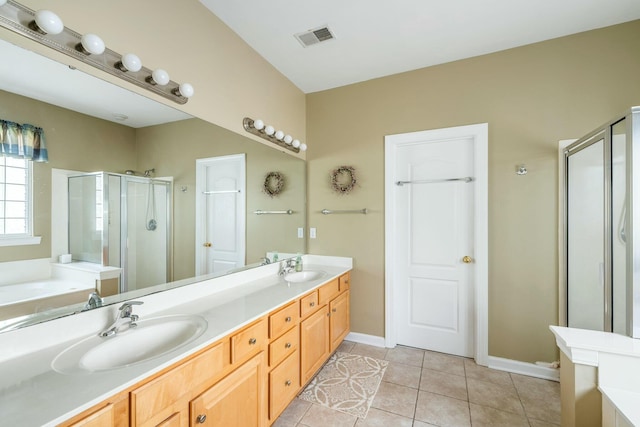 bathroom featuring tile patterned floors, visible vents, a garden tub, a sink, and a shower stall