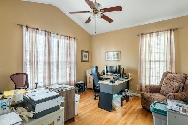 home office with light wood finished floors, baseboards, a ceiling fan, and vaulted ceiling