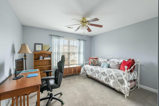 carpeted bedroom featuring a ceiling fan, visible vents, and baseboards