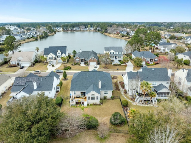 drone / aerial view featuring a residential view and a water view