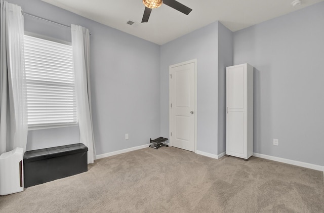 unfurnished bedroom with visible vents, carpet flooring, a ceiling fan, and baseboards