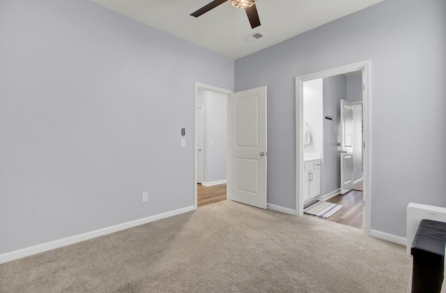 unfurnished bedroom with light colored carpet, visible vents, and baseboards