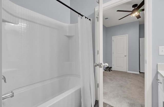 bathroom featuring a ceiling fan, visible vents, shower / bathtub combination with curtain, and vanity