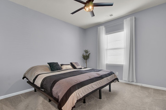 bedroom featuring carpet floors, visible vents, baseboards, and multiple windows