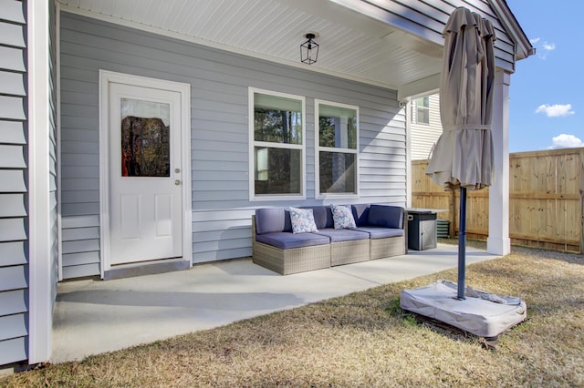 doorway to property featuring covered porch, fence, and outdoor lounge area