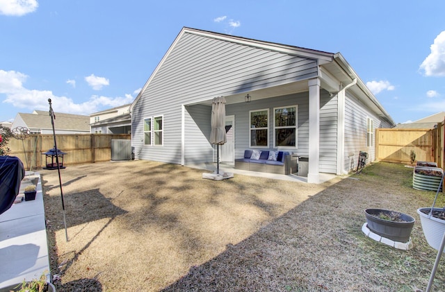 back of property featuring central AC unit and a fenced backyard