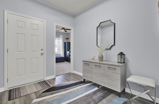 entryway featuring dark wood finished floors and baseboards