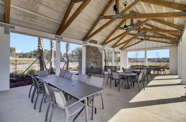 view of patio with a gazebo, outdoor dining space, fence, and a ceiling fan