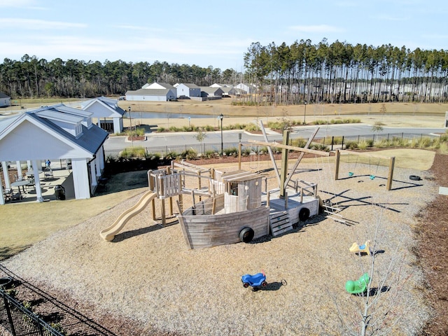 exterior space featuring playground community and fence