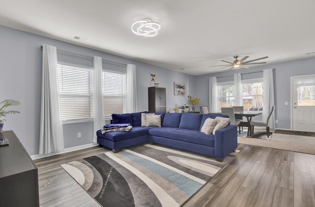 living room featuring wood finished floors and baseboards