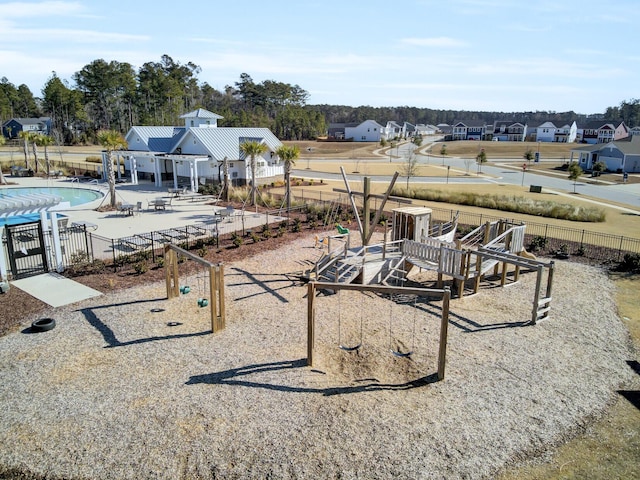 exterior space featuring a patio area, a community pool, and fence