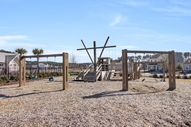 communal playground featuring a residential view and fence