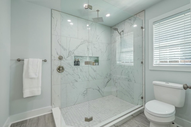 bathroom with tiled shower and toilet