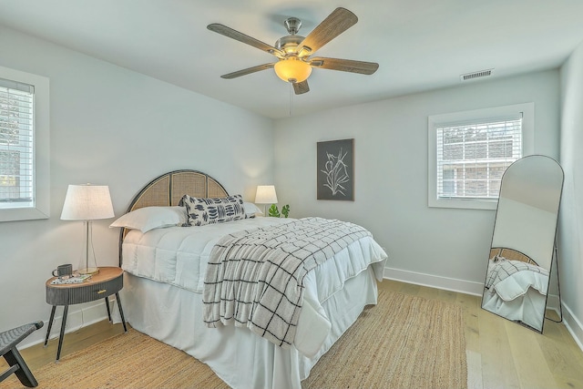 bedroom with light wood-type flooring and ceiling fan