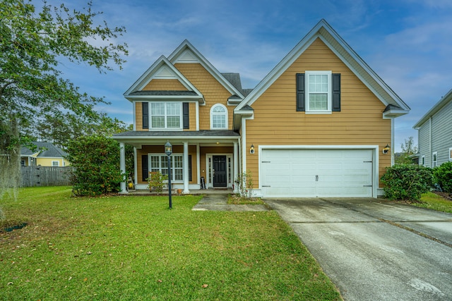 view of front of house with covered porch, a garage, and a front lawn