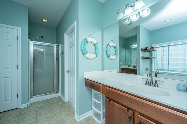 bathroom with walk in shower, vanity, and tile patterned floors