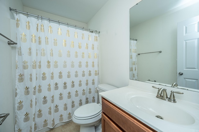 bathroom with tile patterned flooring, vanity, and toilet