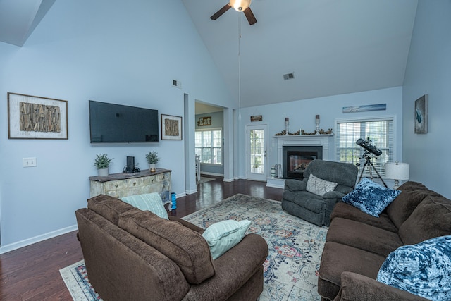 living room with ceiling fan, dark hardwood / wood-style floors, and high vaulted ceiling