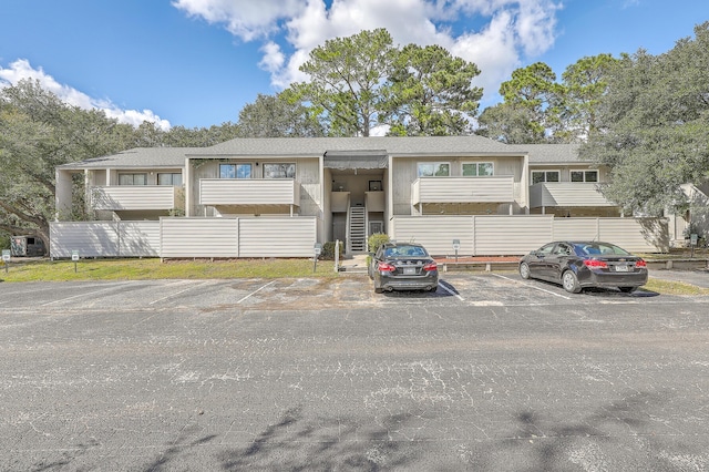 202 Greenmeadow Dr, Goose Creek, SC 29445 - view of front of property featuring fence, a shingled roof, uncovered parking, and stairs