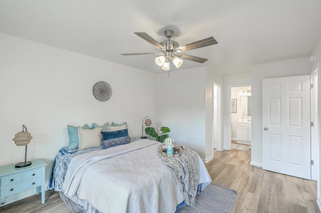 bedroom with light hardwood / wood-style flooring, ensuite bathroom, and ceiling fan