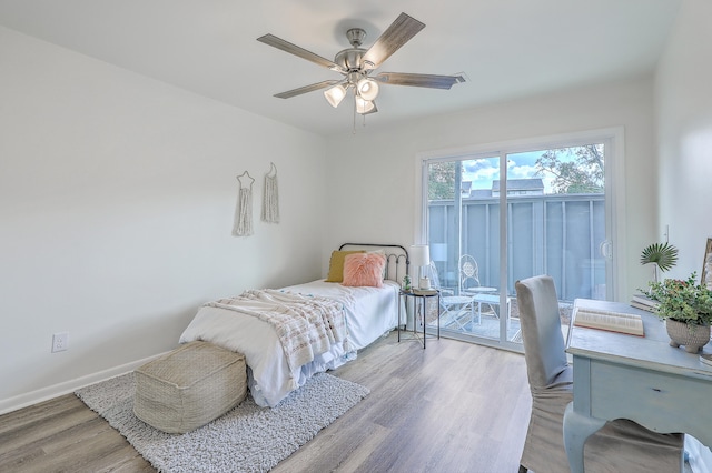 bedroom featuring light hardwood / wood-style flooring, access to exterior, and ceiling fan