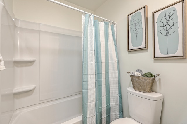 bathroom featuring shower / bath combination with curtain and toilet