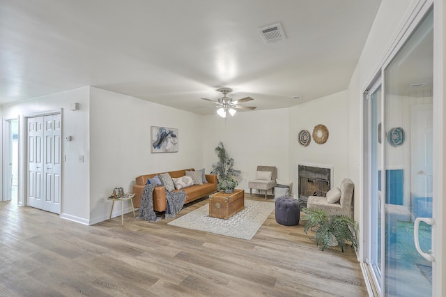 202 Greenmeadow Dr, Goose Creek, SC 29445 - living room with baseboards, visible vents, a ceiling fan, wood finished floors, and a fireplace