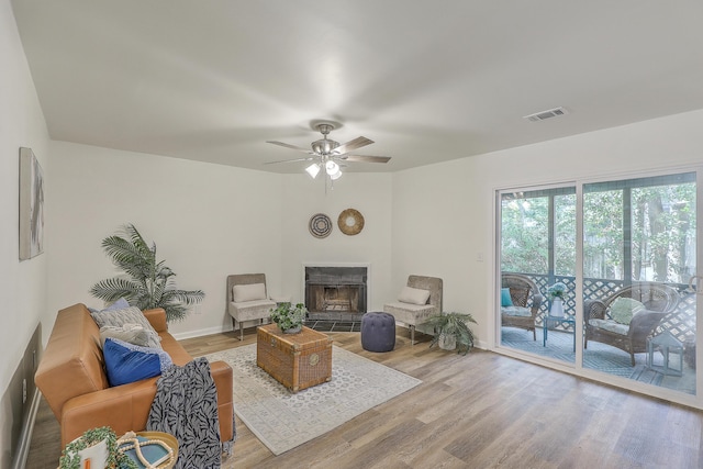 202 Greenmeadow Dr, Goose Creek, SC 29445 - living area with a fireplace with raised hearth, wood finished floors, visible vents, and ceiling fan