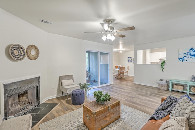 living room featuring wood-type flooring and ceiling fan