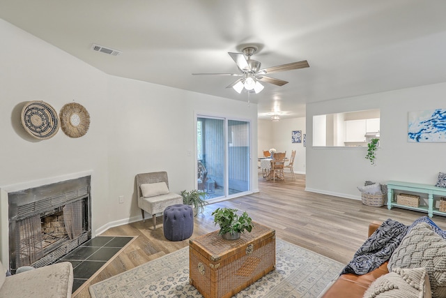 202 Greenmeadow Dr, Goose Creek, SC 29445 - living area featuring a fireplace with flush hearth, wood finished floors, visible vents, baseboards, and ceiling fan