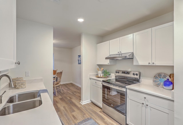 202 Greenmeadow Dr, Goose Creek, SC 29445 - kitchen with white cabinets, light wood-style flooring, a sink, stainless steel electric range oven, and under cabinet range hood