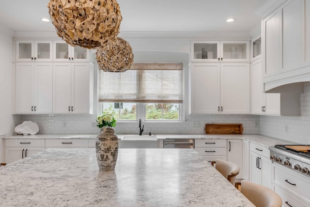 kitchen with white cabinets, sink, decorative backsplash, appliances with stainless steel finishes, and light stone counters