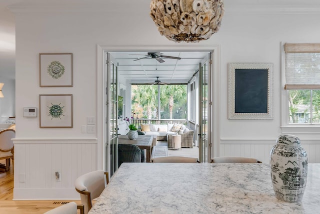 dining room with crown molding, plenty of natural light, ceiling fan, and hardwood / wood-style floors