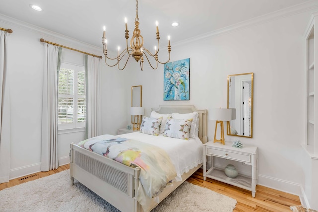 bedroom with an inviting chandelier, light hardwood / wood-style flooring, and ornamental molding