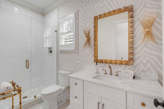 bathroom with vanity, toilet, and a shower with door