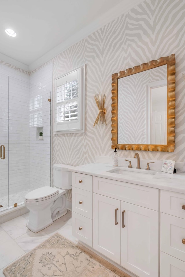 bathroom featuring vanity, toilet, and a shower with door