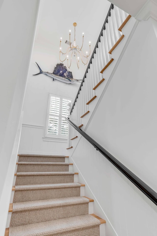 stairway with a chandelier