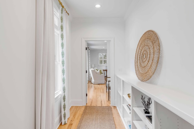 corridor featuring hardwood / wood-style flooring and ornamental molding